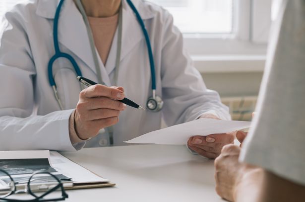Unrecognizable female doctor consulting patient.