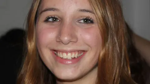 Figueiredo family Alice Figueiredo close-up on face. She smiles and looks slightly off-camera